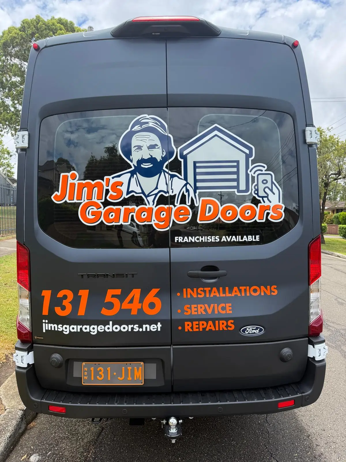 Jim’s Garage Doors service van showing branding, contact number and repair, service and installation offerings