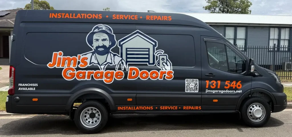 Jim’s Garage Doors service van displaying installations, service and repairs with contact details and branding